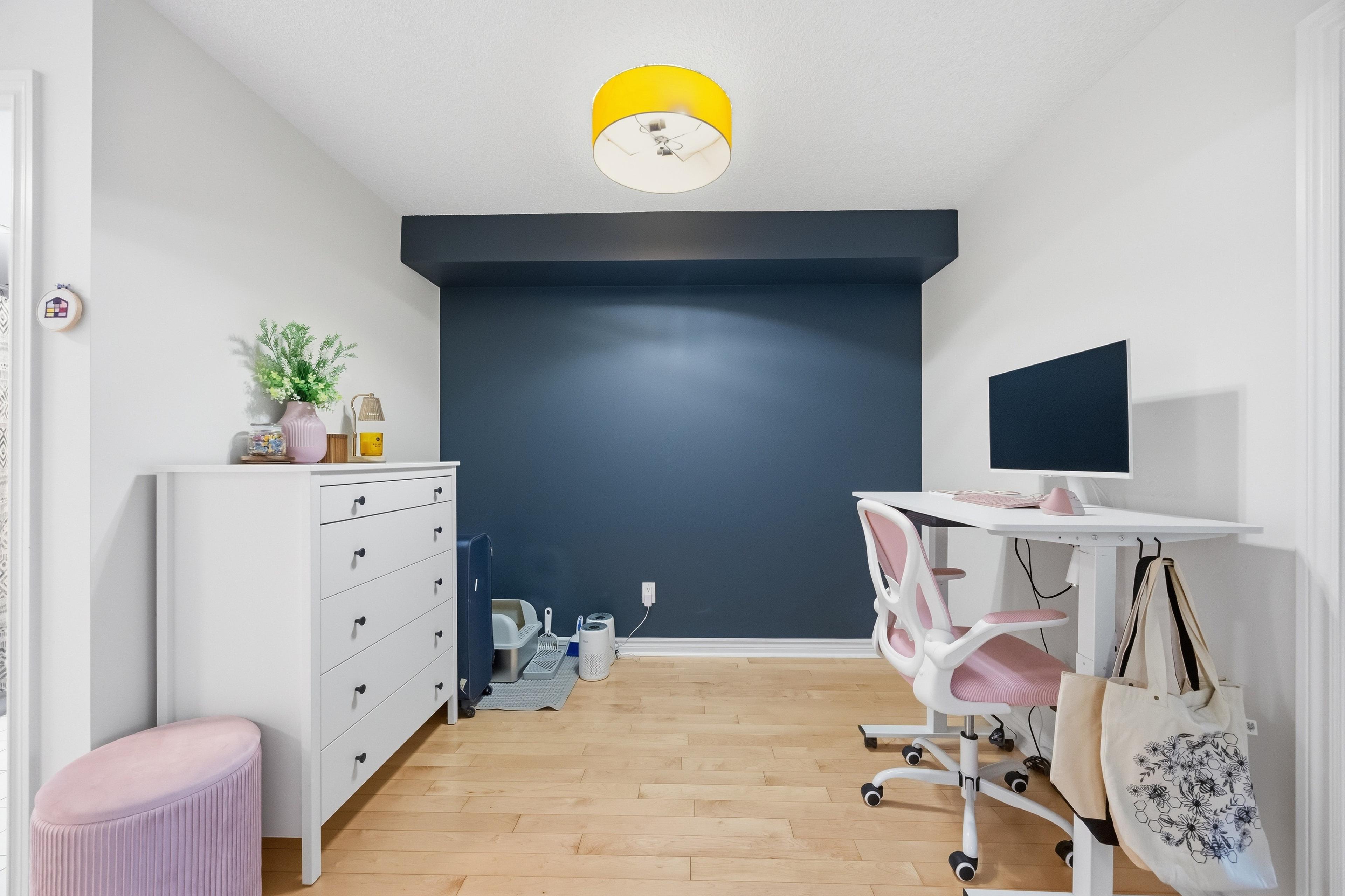 Den with blue accent wall — office or flex space