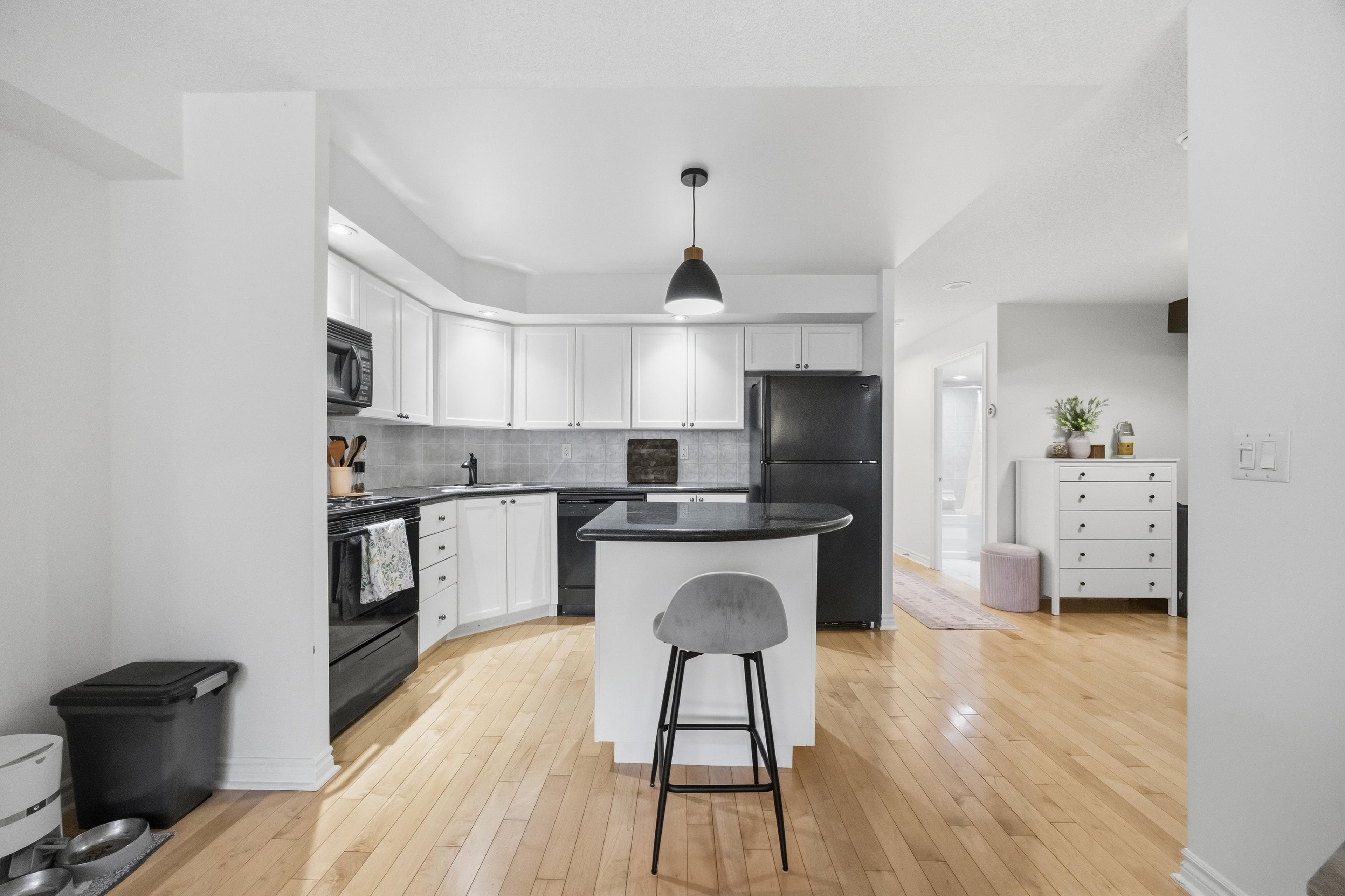 Kitchen with breakfast bar seating and full-size appliances