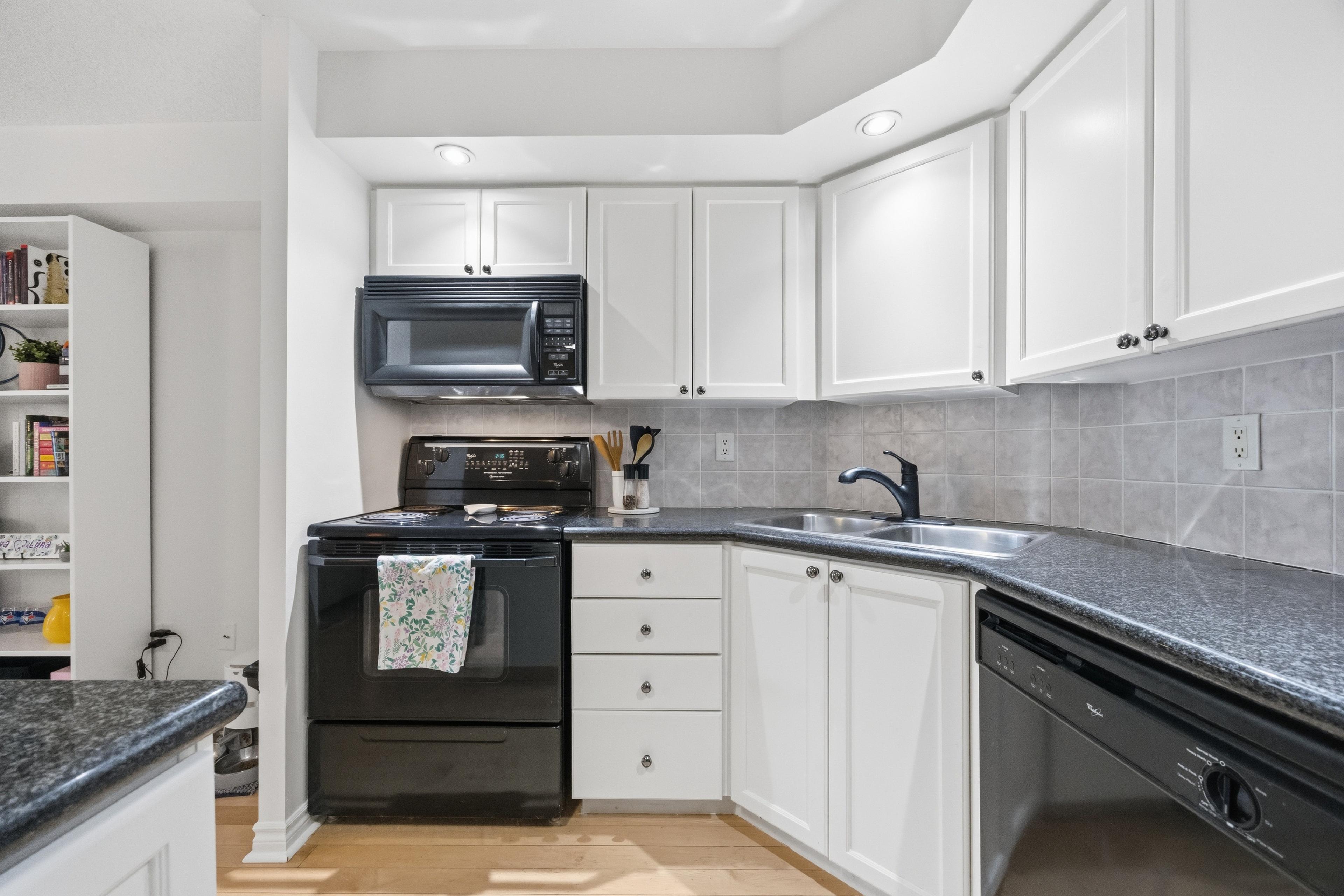 Kitchen with full-size appliances and backsplash