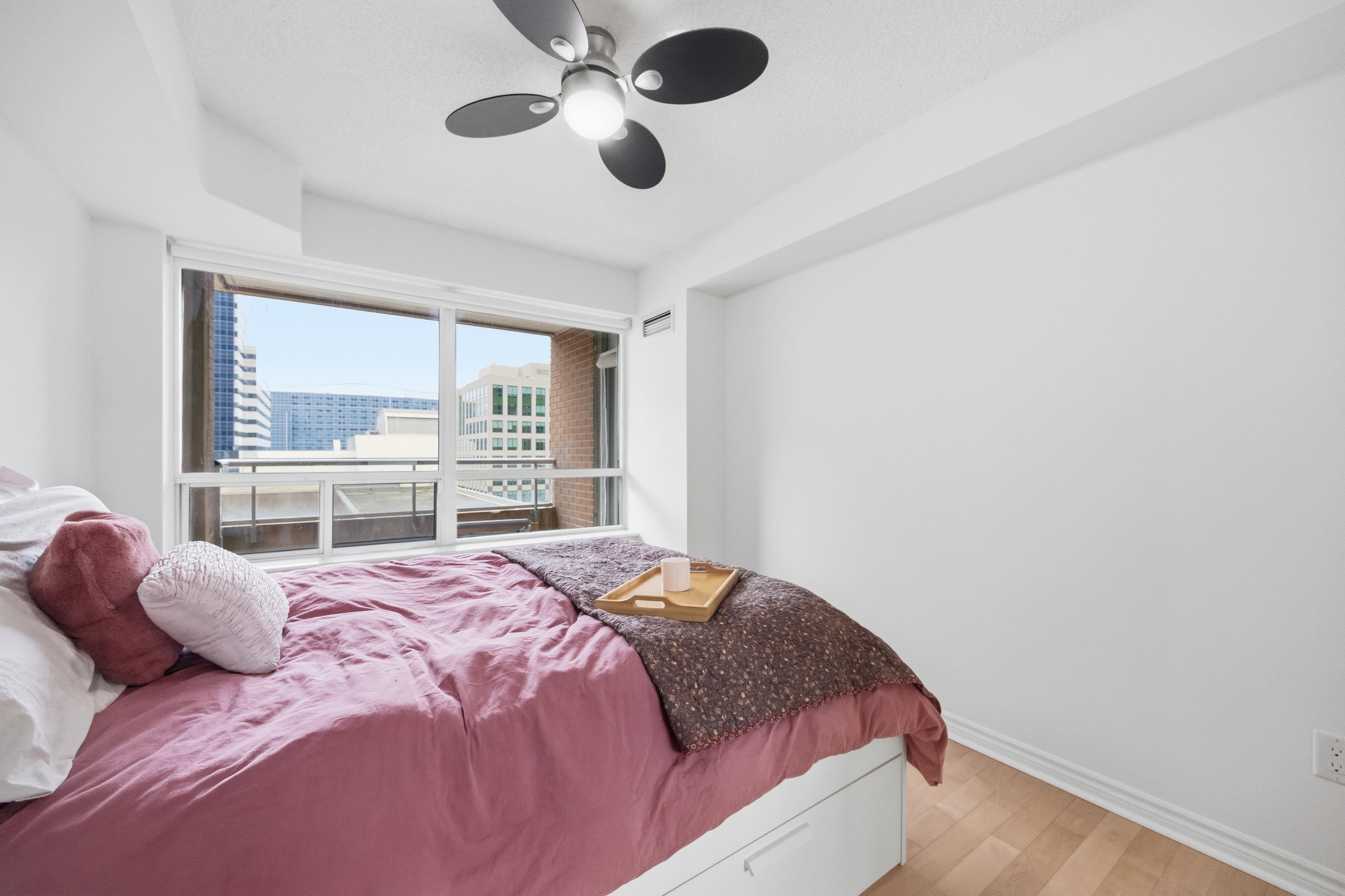 Primary bedroom with south-facing window and city views