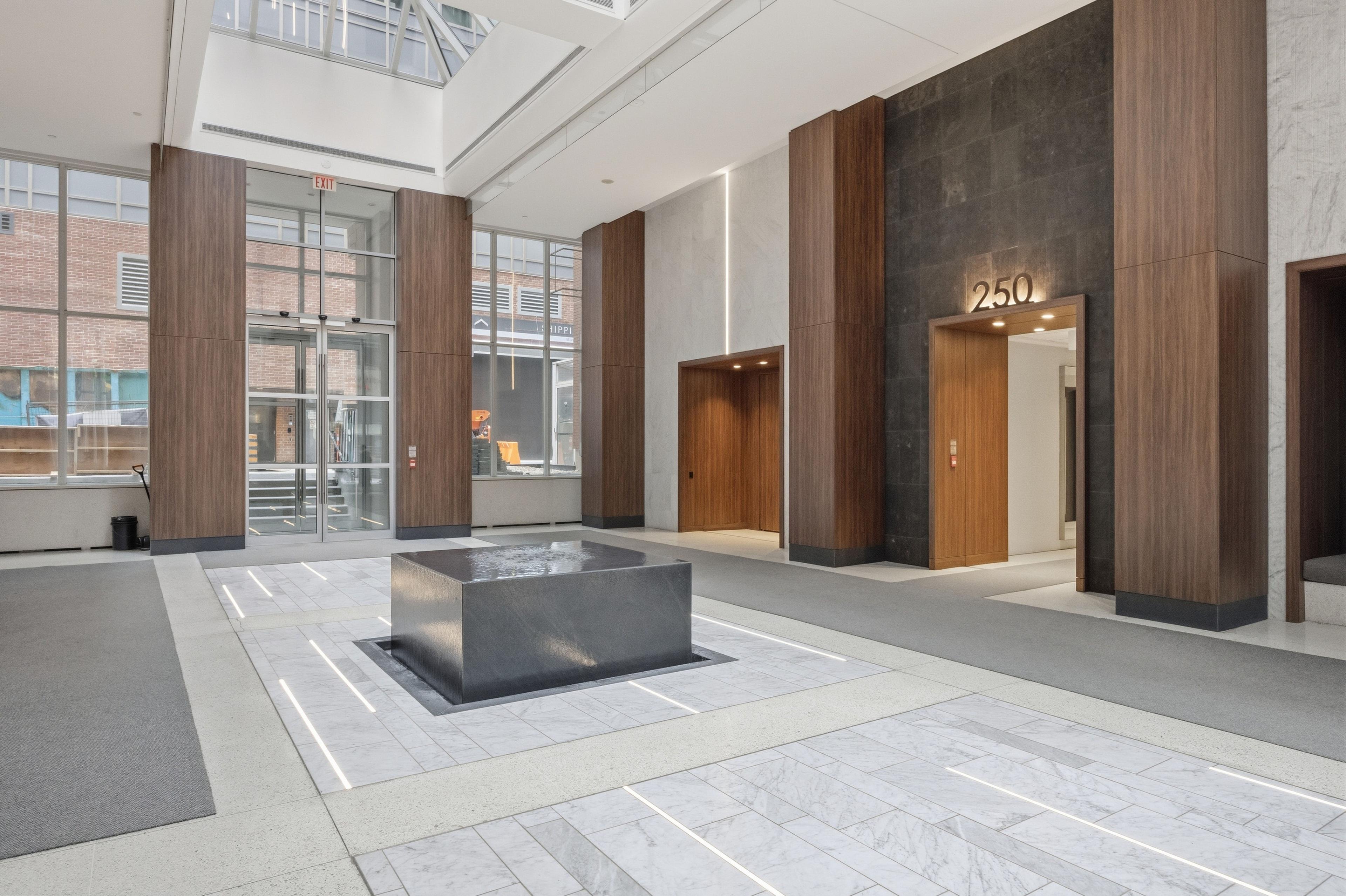 Modern lobby with marble floors and wood accents