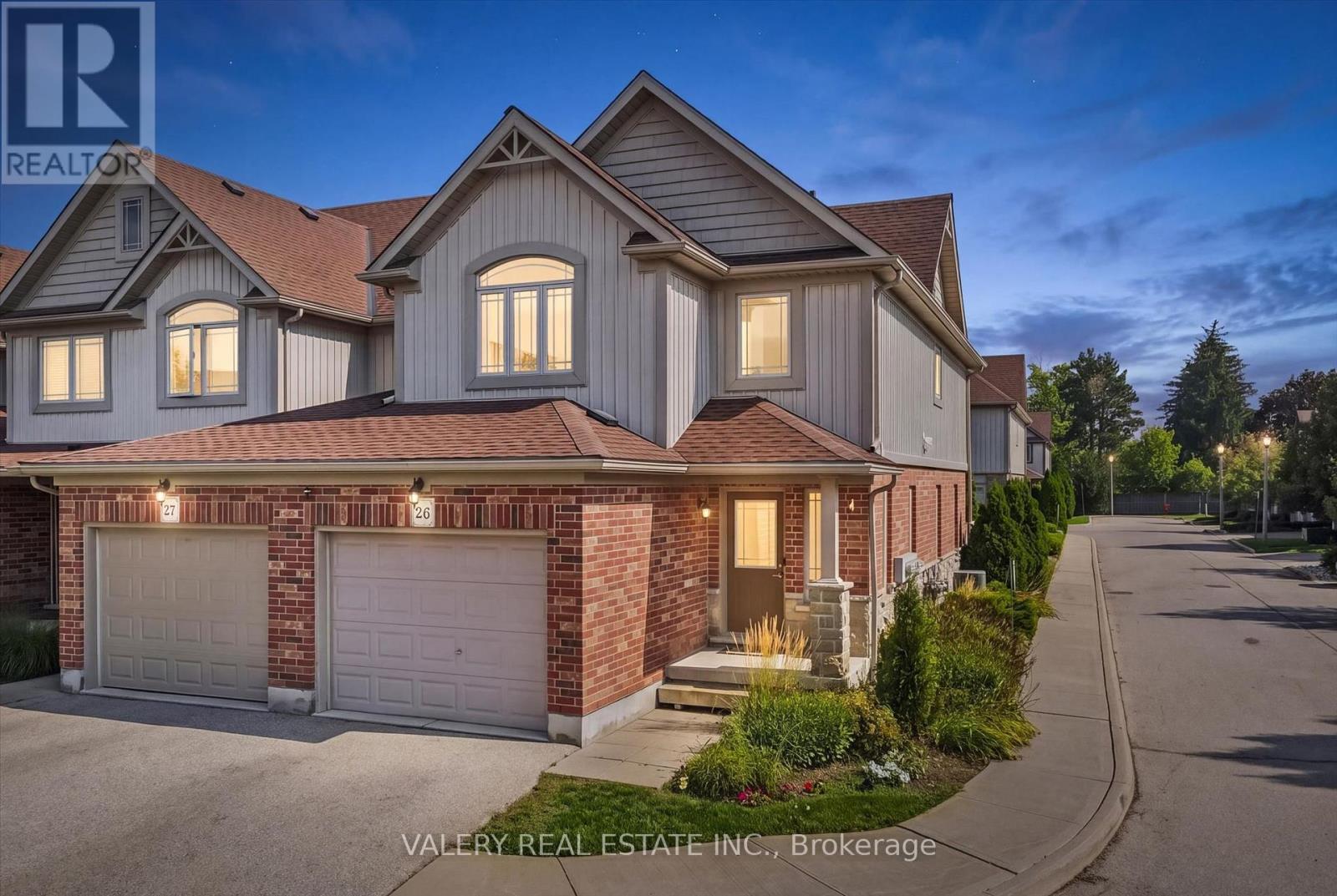 26 - 355 MacAlister Boulevard — end-unit townhome exterior at dusk