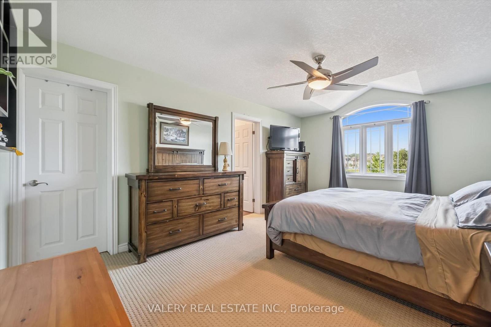 Primary bedroom with hardwood flooring