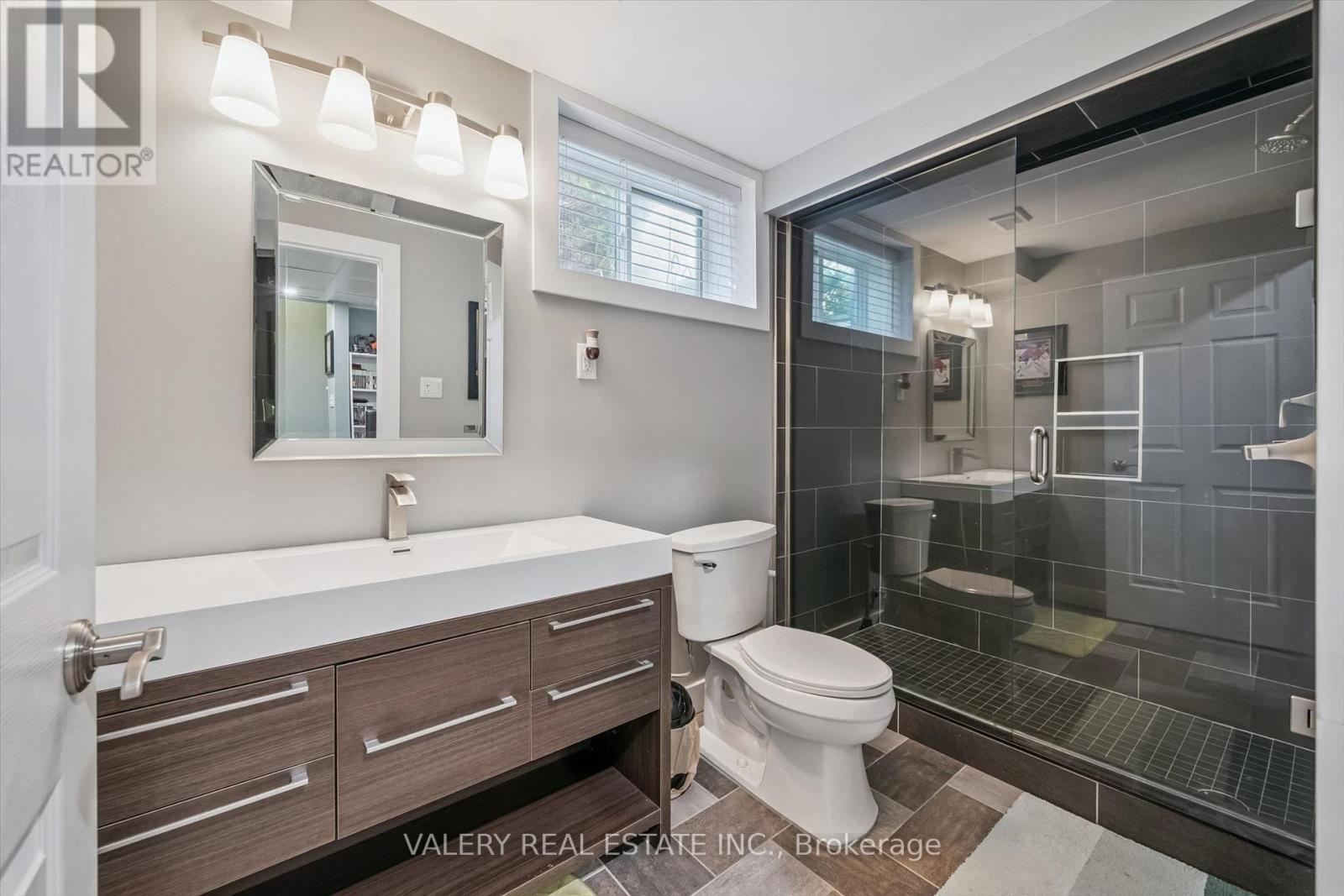 Basement three-piece bathroom with glass shower