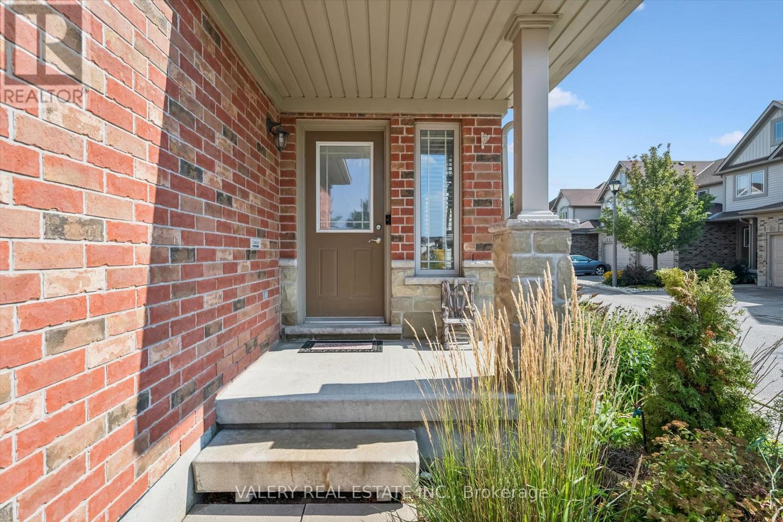 Covered front entrance with brick surround