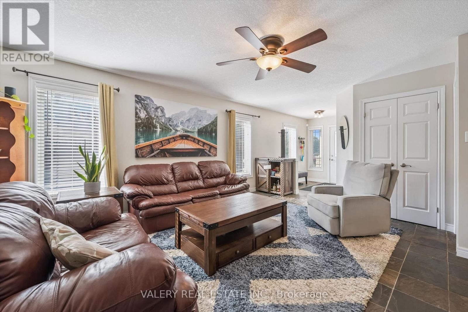 Living room with large window and ceiling fan