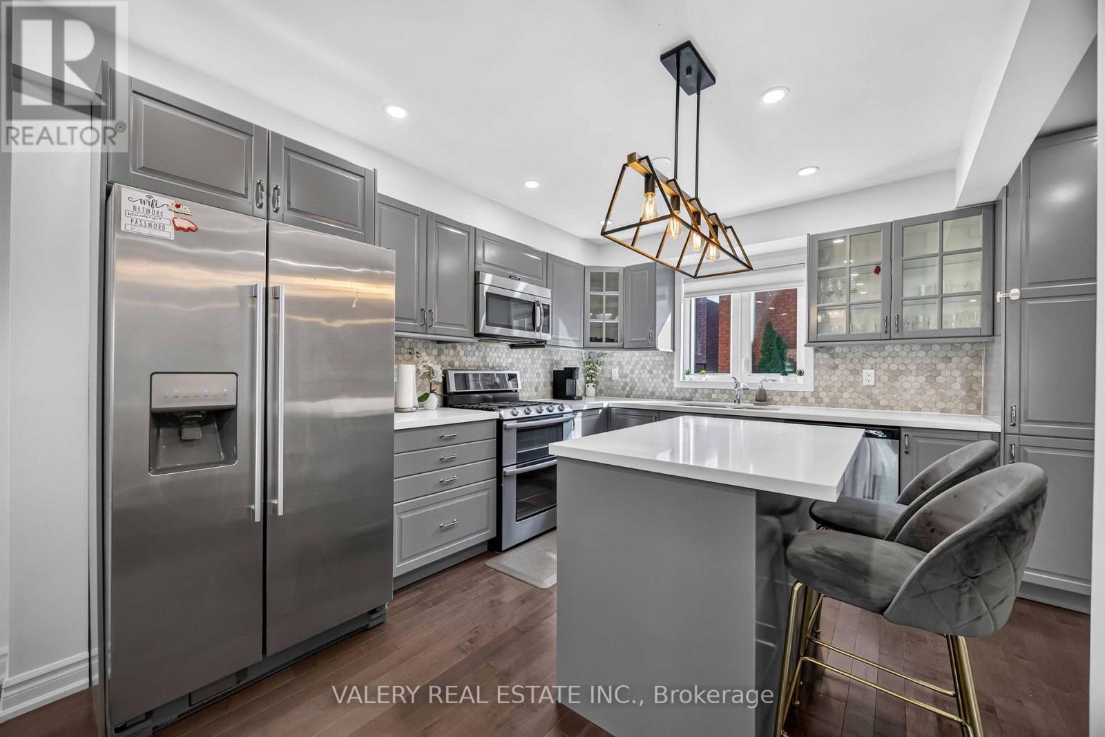 Renovated kitchen with stainless steel appliances and island