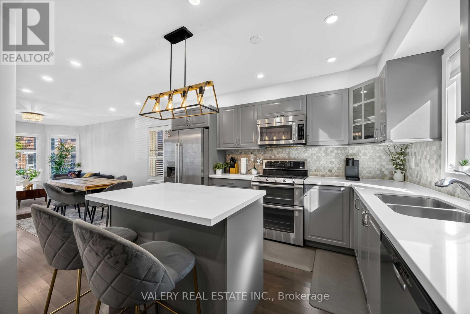 Kitchen with quartz counters and tile backsplash