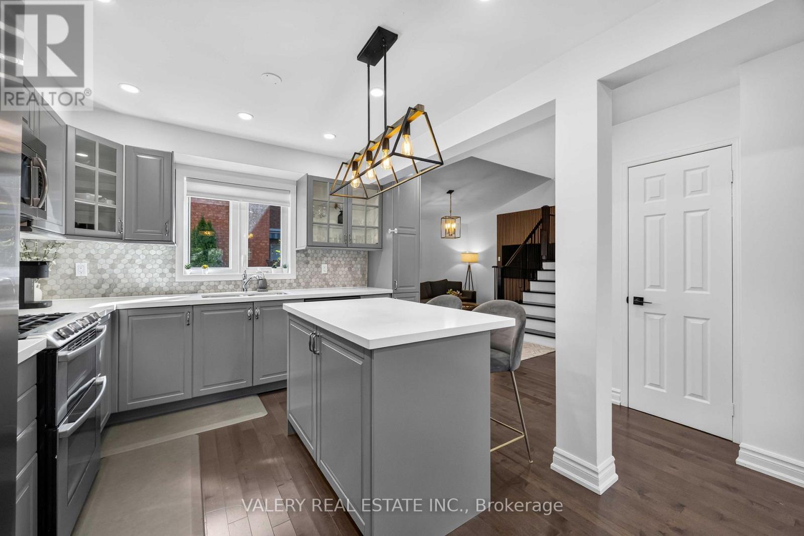 Kitchen with centre island and view to the staircase