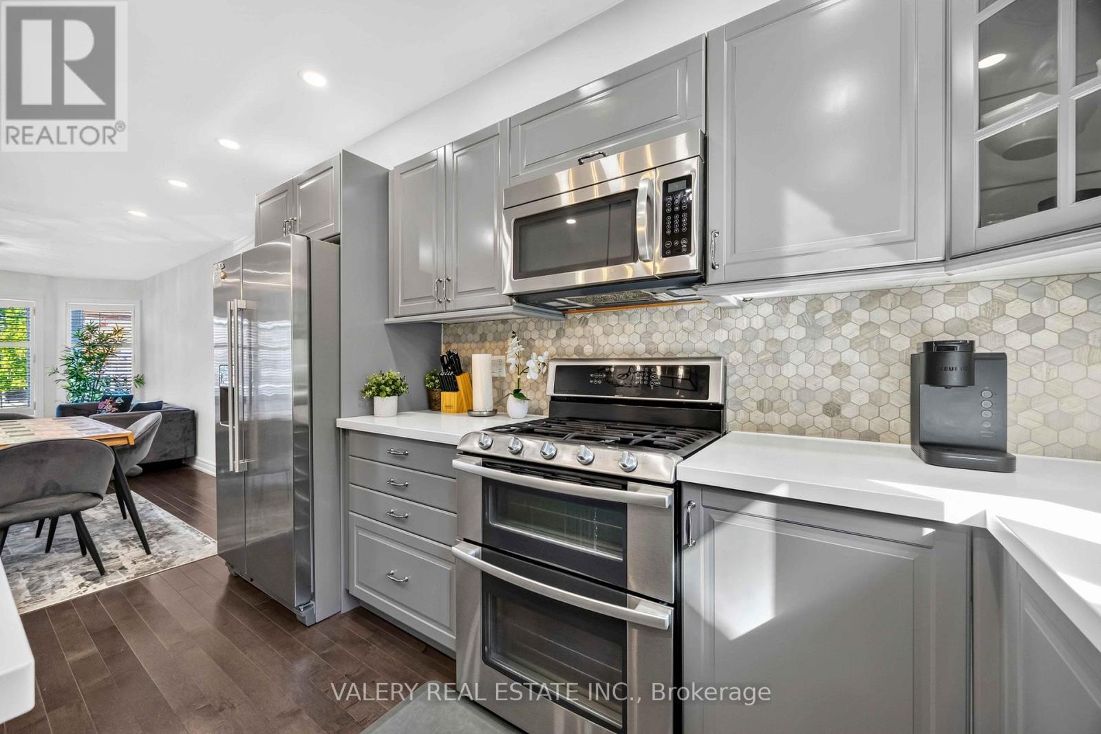 Kitchen with gas range and microwave