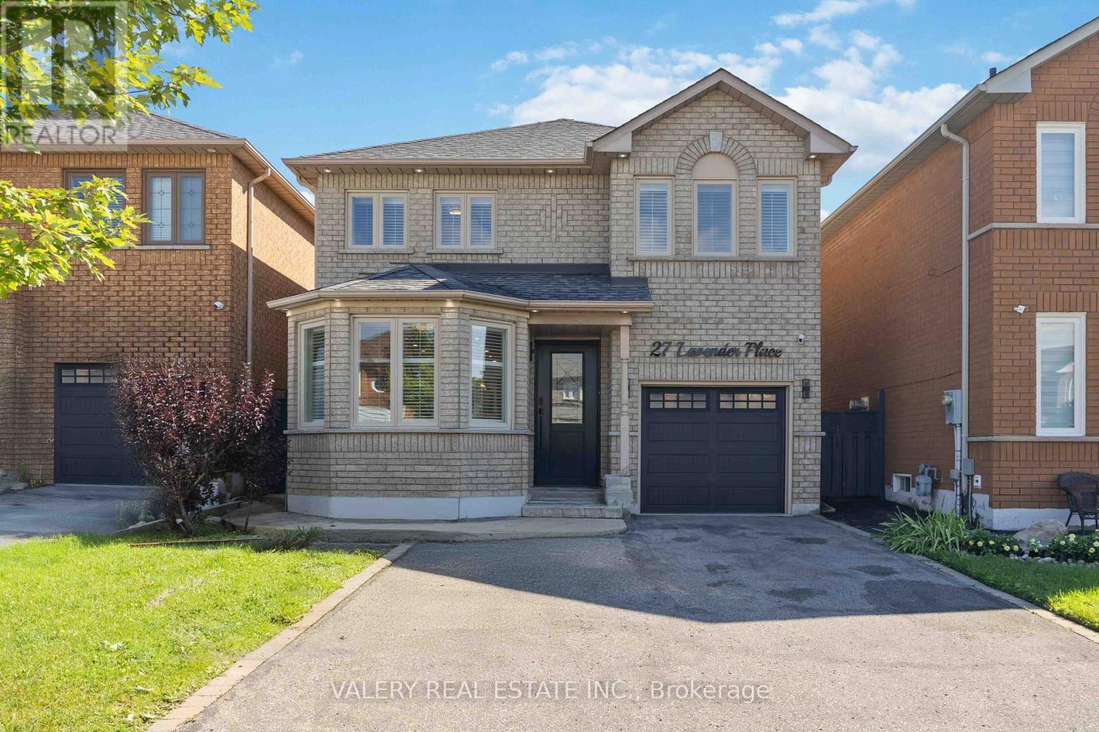 Front exterior — detached brick home with private driveway