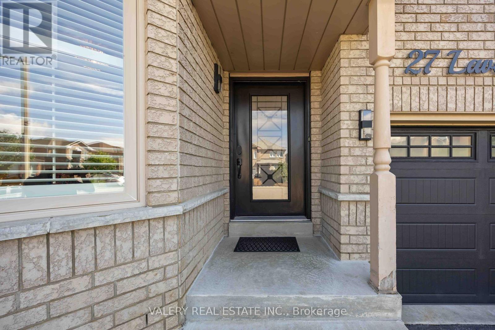 Covered front entrance with dark door