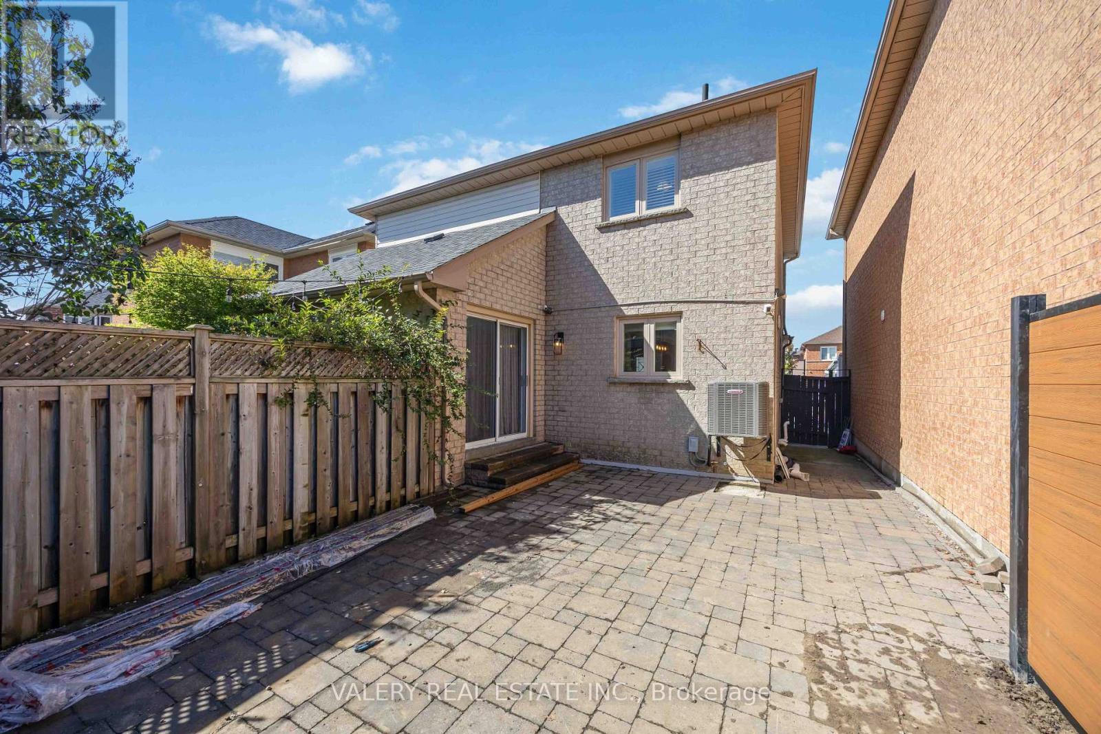 Private backyard with interlock patio and fence