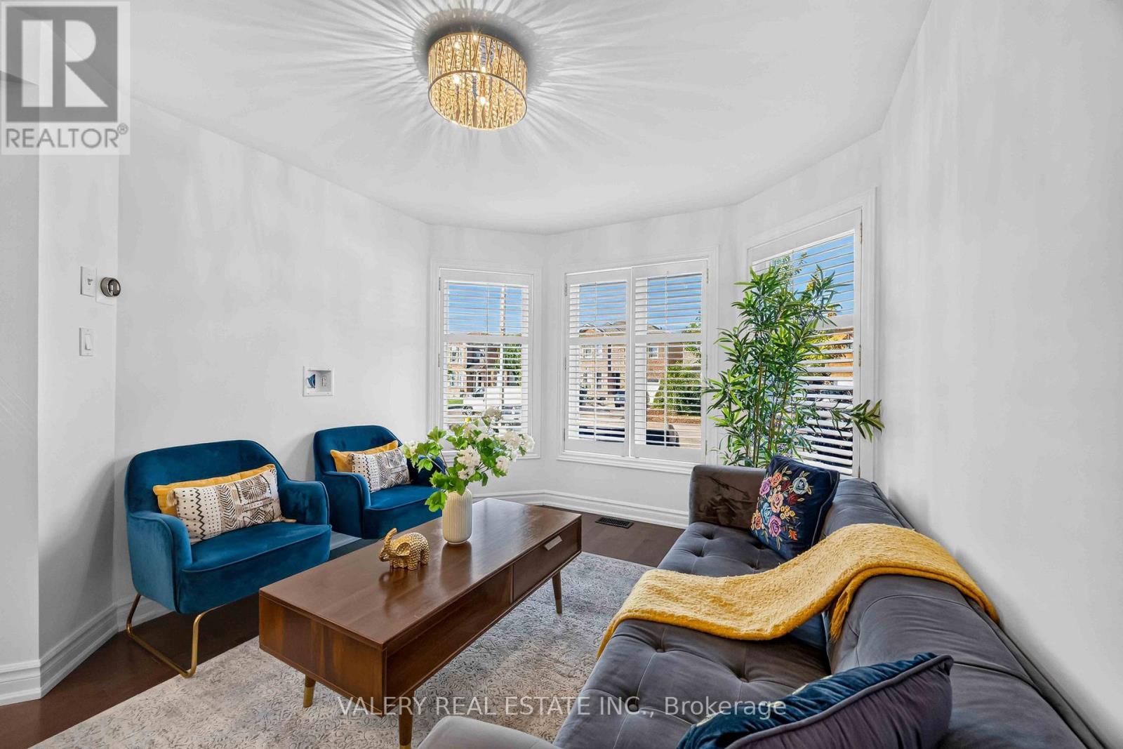 Living room with bay window and plants